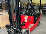 a red fork truck parked in a warehouse with boxes on the floor