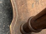a close up of a wooden table with a plant design on it