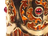 a close up of a gold cuff with red stones on it
