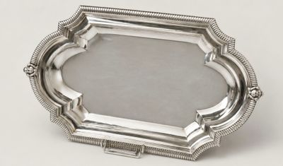 a silver plate with a decorative design on it