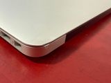 a close up of a laptop on a red surface