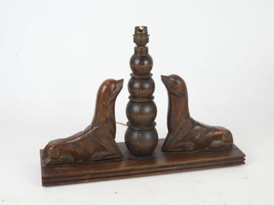wooden table lamp with two birds on top of it on a stand