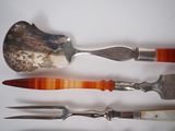 three different types of silverware on a white surface