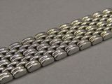 an image of a close up of a metal bracelet on a table