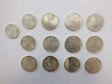 several different coins are arranged in a circle on a white surface