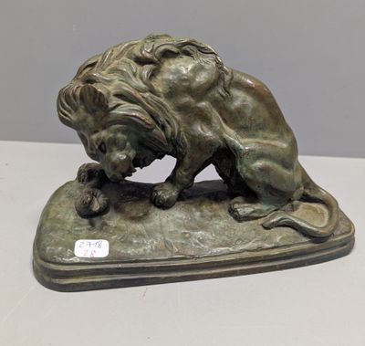 bronze statue of a lion on a base on a table