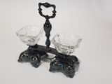 a black candle holder with two crystal glasses on it