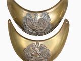 two brass plates with birds on them on a white background