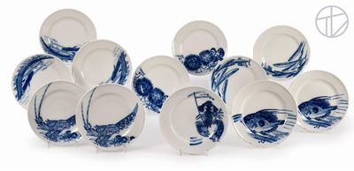 a lot of blue and white plates on a white surface