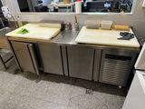 stainless steel counter top with two cutting boards on top of it