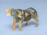 a figurine of an oxen bull on a blue background