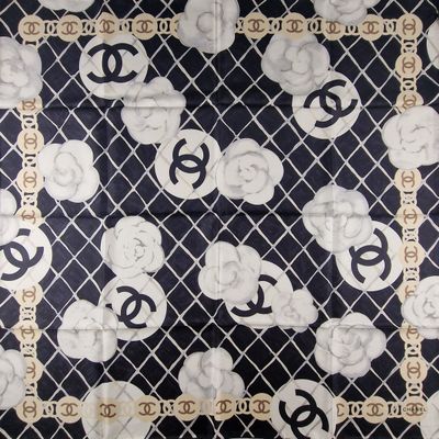 a black and white scarf with white flowers on it