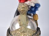 a helmet with a red, white, and blue feather on it