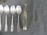 five spoons and two spoons sitting on a table