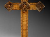 an ornate wooden cross on a white surface with a black background