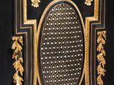 a black and gold cabinet with gold decorations on it