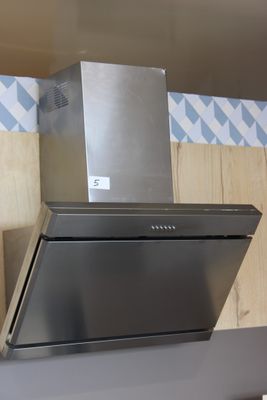une hotte en acier inoxydable fixée au mur de la cuisine