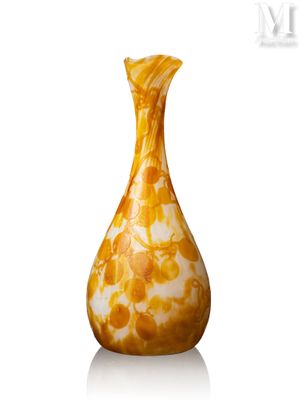 un vase jaune posé sur une surface blanche