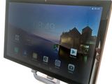 someone is holding a tablet with a picture of a building in the background