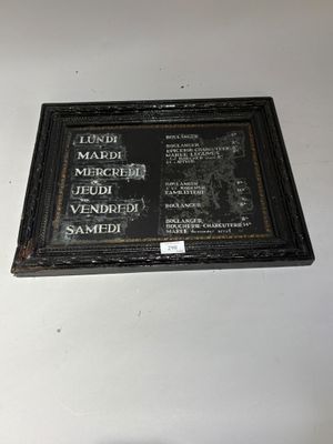 a plaque on the wall of a building that has a picture of a man on it