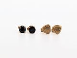 a pair of black diamond stud earrings on a white surface
