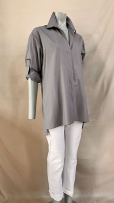 the mannequin is wearing a gray shirt and white pants
