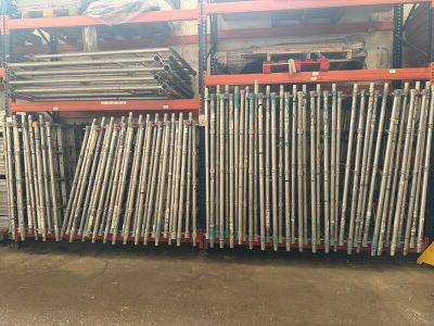 a large pile of steel rods stacked on top of each other in a warehouse