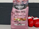 a bag of grain free dog food next to a pair of mittens