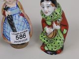 two salt and pepper shakers sitting next to each other