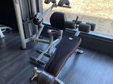 a gym room with a bench, weights, and other equipment