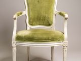 une chaise blanche et verte dont l'assise est rembourrée de vert