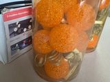 oranges in a glass jar on a table