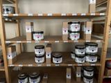 many cans of paint on the shelves in the room