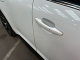 a white car parked in a parking lot with its door open