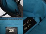 the inside of a blue purse with a tag on it