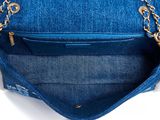 the inside of a blue purse with a chain hanging from it