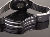 a close up of a watch on a black surface