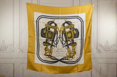 a yellow and black scarf hanging on a wall