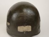 an old helmet with a hole in the middle of it