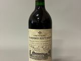 an old bottle of wine sitting on top of a table