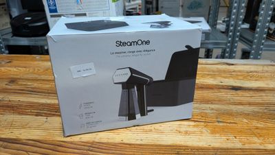packaging of a black coffee maker sitting on top of a wooden table