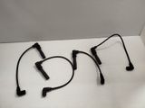 two black wires are sitting on top of a white table