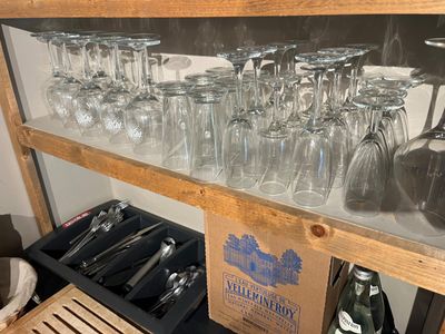 many glasses on a shelf in the kitchen