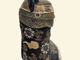 a statue of a woman sitting on top of a vase