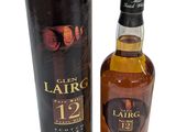a bottle of whisky sitting next to a black box