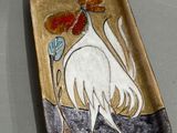 a plate with a rooster on it on a table