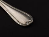 a spoon that is sitting on a black surface