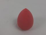 a pink sponge sitting on a white surface