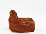 a brown bean bag chair sitting on top of a white floor