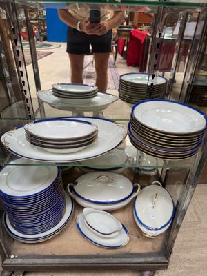 a glass display case with plates and bowls on it